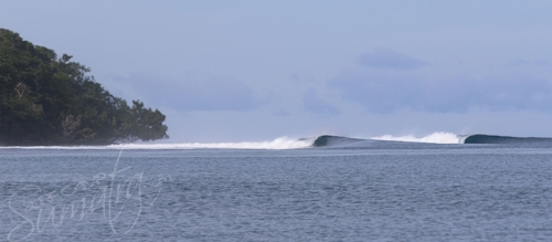 A remote left grinds down the reef in the Banyaks